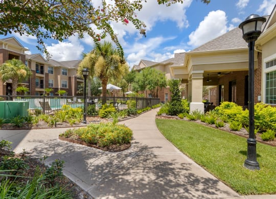 walking path to apartment buildings at Madison on the Meadow, Stafford, Texas