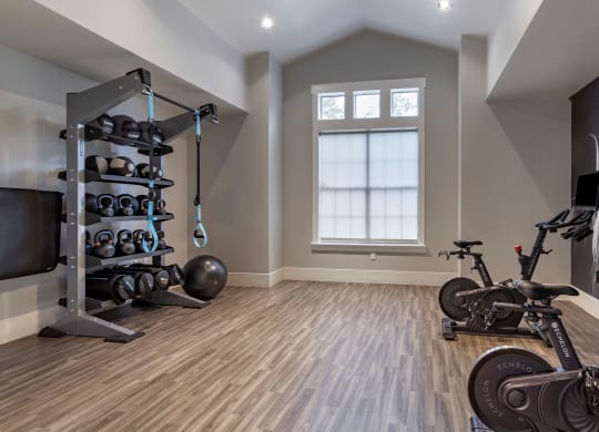 a home gym with exercise equipment and a bike at Reserve by the Lake, Houston, Texas