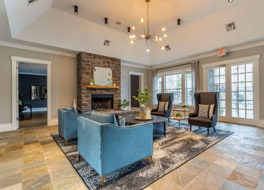 a living room with couches and chairs and a fireplace at Reserve by the Lake, Houston, TX, 77084