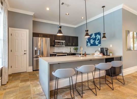a kitchen with a bar and stools at Reserve by the Lake, Houston