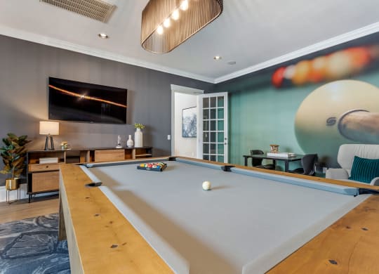a game room with a pool table and a tv at Reserve by the Lake, Houston, TX, 77084
