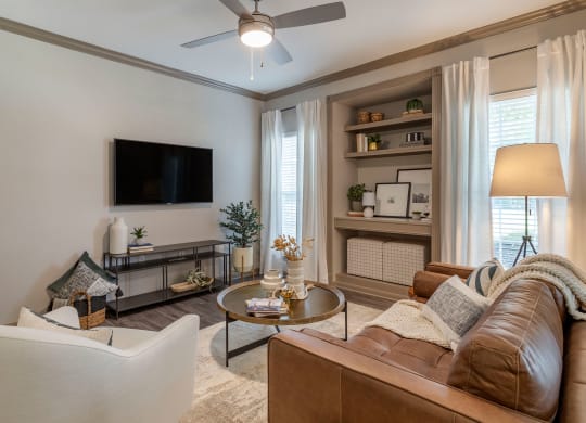 a living room with a couch and a tv at Reserve by the Lake, Houston, Texas