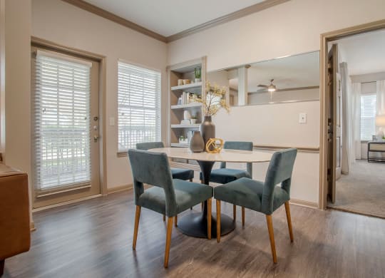 a dining room with a table and chairs in front of a window at Reserve by the Lake, Texas