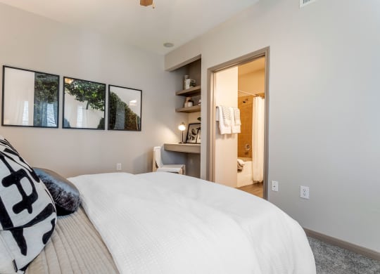 a master bedroom with a large bed and a bathroom at Reserve by the Lake, Houston, Texas