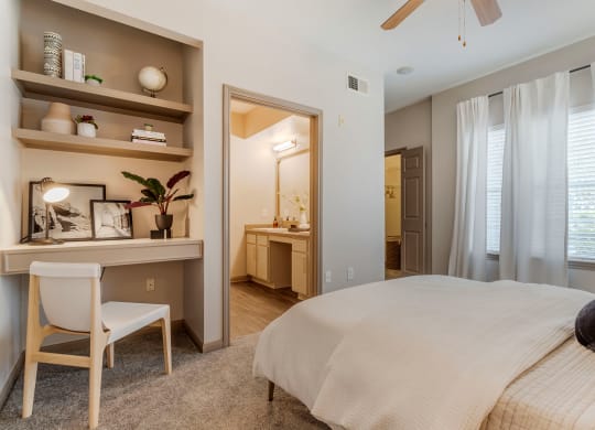 a bedroom with a bed and a desk with a mirror at Reserve by the Lake, Houston, Texas