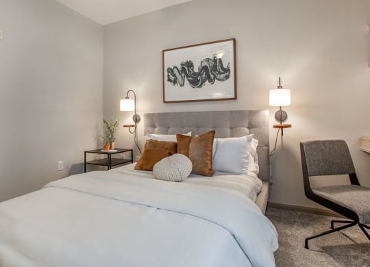 a bedroom with a large white bed and pillows at Reserve by the Lake, Houston, Texas