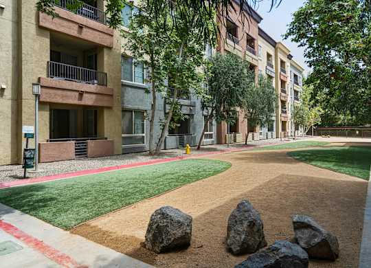 A large rock sits in the middle of a dirt path at The Kitt at Warner Center Apartments, Woodland Hills, CA