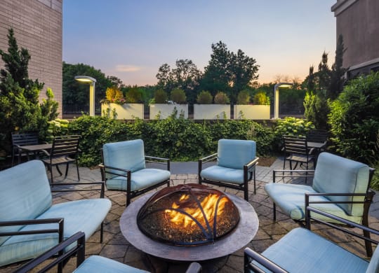 an outdoor patio with a fire pit and chairs at 15 Bank Apartments, White Plains, NY, New York, 10606