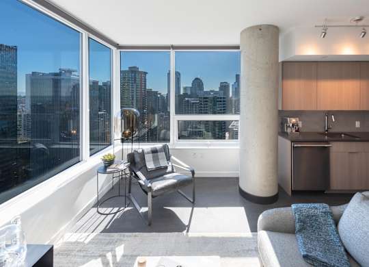 A modern living room with a view of the city skyline.