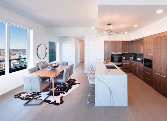 A modern kitchen with a dining table and chairs.
