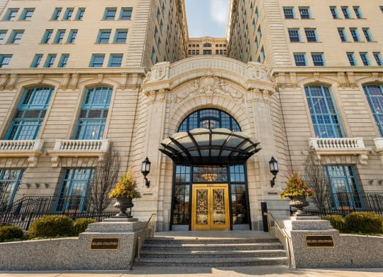 a large building with a golden door and stairs in front of it  at The Belden Stratford, Chicago, IL