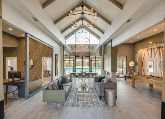 a living room with couches and a table with a pool at Carrington at Barker Cypress, Texas, 77433