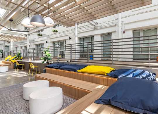 a common room with beds and a table and chairs at Highland Mill Lofts, Charlotte, 28205