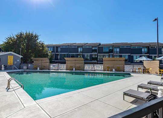 a swimming pool with a building in the background at Highland Mill Lofts, Charlotte, NC