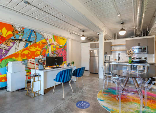 a living room with a kitchen and a table and chairs at Highland Mill Lofts, Charlotte, 28205