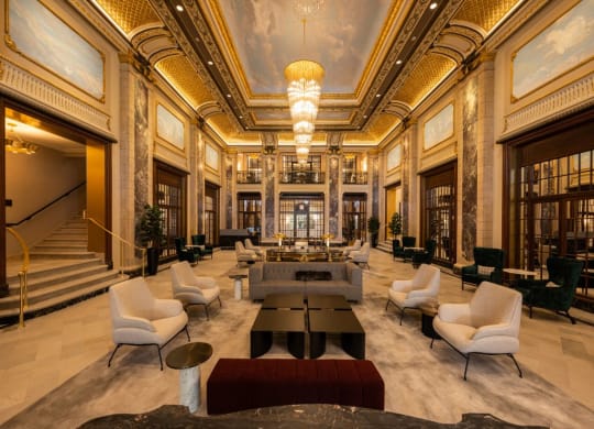 a rendering of the lobby with a reception area and chairs and tables  at The Belden Stratford, Chicago, 60614