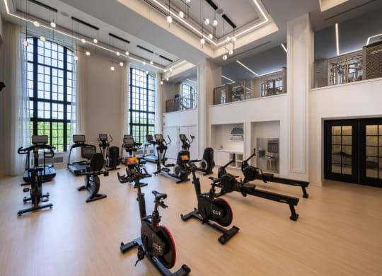 a gym with weights and exercise equipment in a large room  at The Belden Stratford, Chicago, IL
