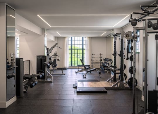 a gym with a lot of exercise equipment and a window  at The Belden Stratford, Chicago, IL, 60614