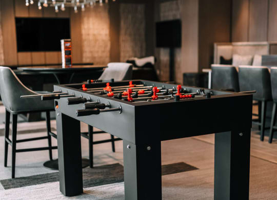 a game room with a foosball table and chairs at The Grand Central, Illinois