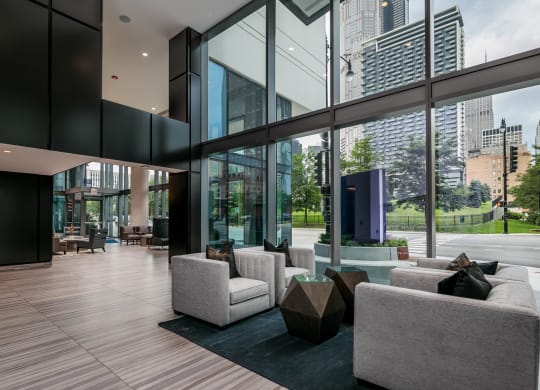 the living room has floor to ceiling windows and views of the city at The Grand Central, Chicago Illinois