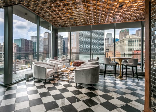a room with a view of the city and a checkered floor and tables at The Grand Central, Chicago, IL 60607