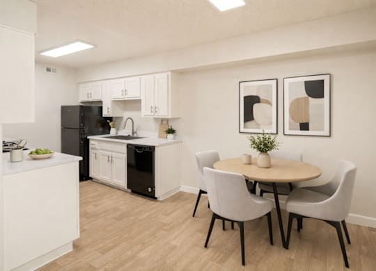 A kitchen with a table and chairs.