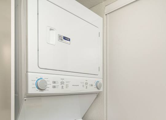 A white dishwasher with a control panel on top.