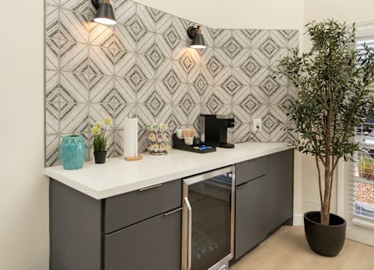 A modern kitchen with a black and white patterned backsplash.
