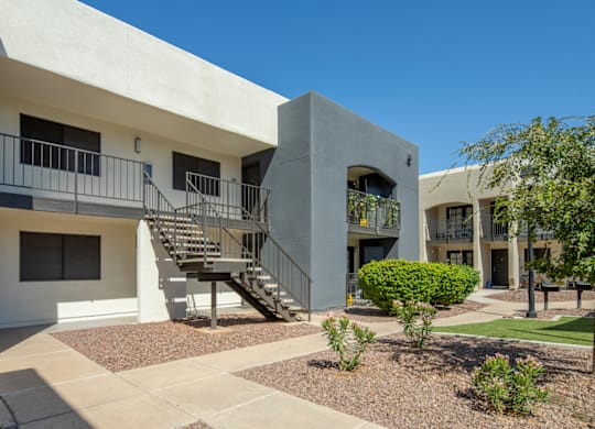 A concrete building with a staircase leading to the second floor.