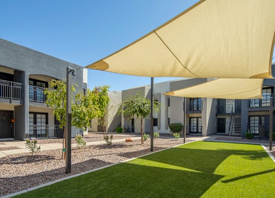 A modern building with a green lawn in front.