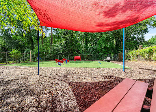 Shaded seating area within the pet play area at Georgian Oaks Apartments l & ll* Apartments, Smyrna , GA