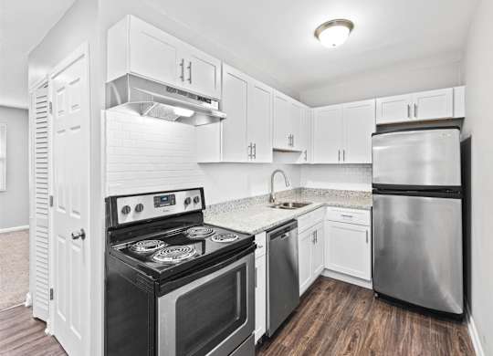 Upgraded kitchen with white cabinets and stainless steel appliances at Georgian Oaks Apartments l & ll* Apartments, Georgia