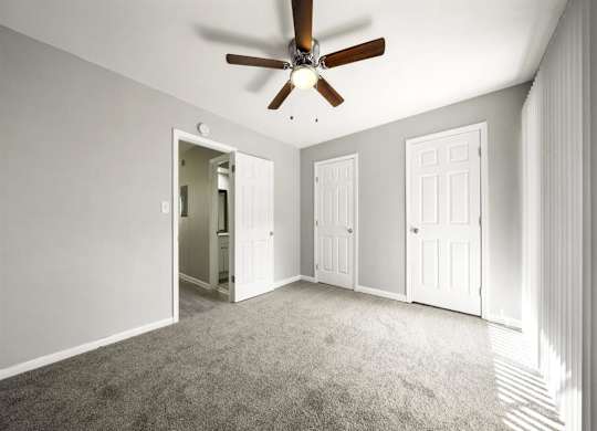 Master bedroom with ceiling fan and light1 at Georgian Oaks Apartments l & ll* Apartments, Georgia