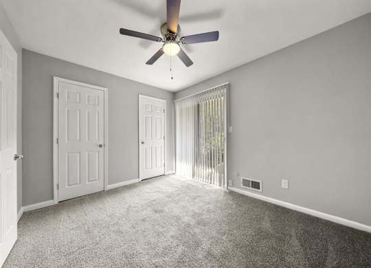 Master bedroom with ceiling fan and light at Georgian Oaks Apartments l & ll* Apartments, Smyrna