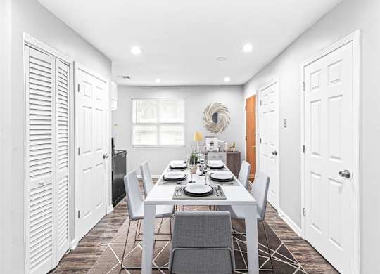 Dining room with a white table and chairs at Georgian Oaks Apartments l & ll* Apartments, Smyrna , GA