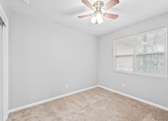 an empty bedroom with a ceiling fan at Georgian Oaks Apartments l & ll* Apartments, Smyrna , Georgia