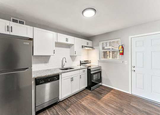 White Cabinetry And Appliances In Kitchen at Gardens at Washington Park, Atlanta