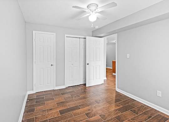 a living room with white doors and a ceiling fan at Gardens at Washington Park, Atlanta, GA, Georgia , 30314