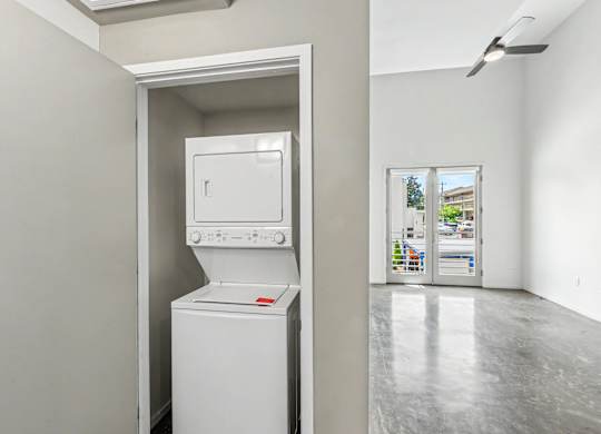 A white washing machine is in a small room.