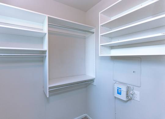 Empty white shelves in a room.