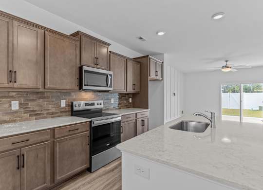 A kitchen with brown cabinets and a white countertop.