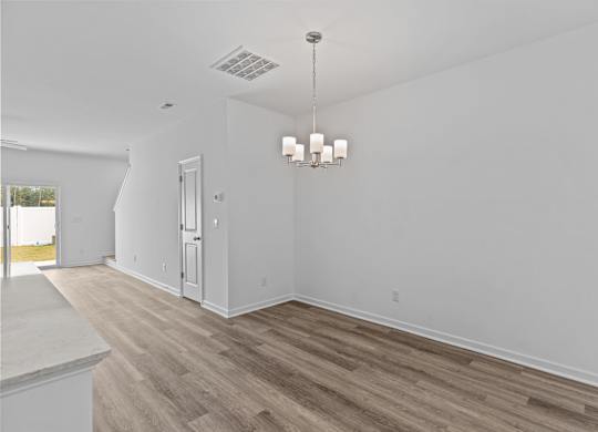 A room with a wooden floor and a chandelier.