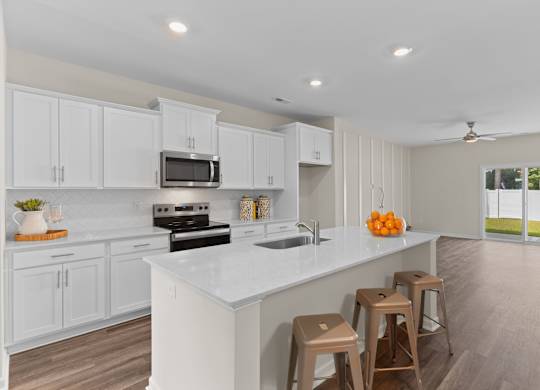 A kitchen with white cabinets and a white counter top.