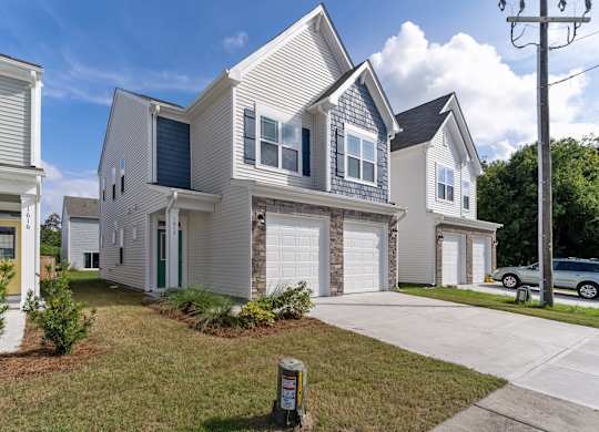 a white house with a white garage door in front of it
