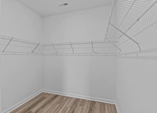 Empty room with white walls and wooden floor.