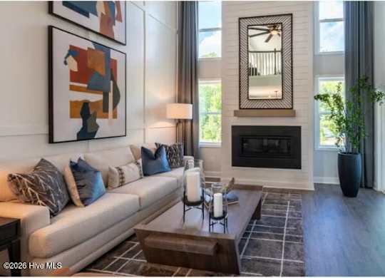 A living room with a fireplace and a painting on the wall.
