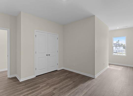 A room with a white door and a window.