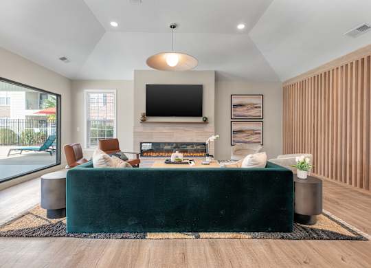 a living room with a green couch and a fireplace