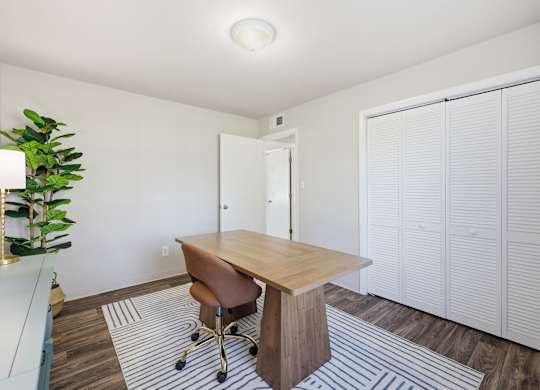 A room with a desk and a chair.