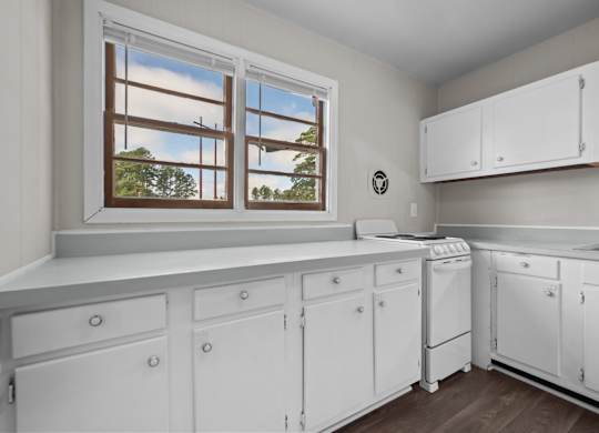 A laundry room with a window and a washer and dryer.